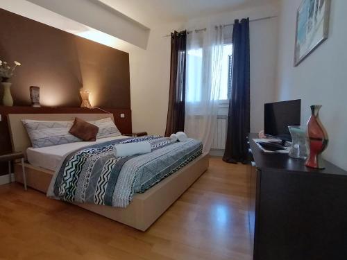 a bedroom with a bed and a desk with a computer at Taormina Panoramic - Taormina Holidays in Taormina