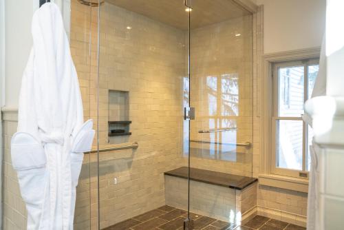 a shower with a glass door in a bathroom at Public House Lofts in Crested Butte