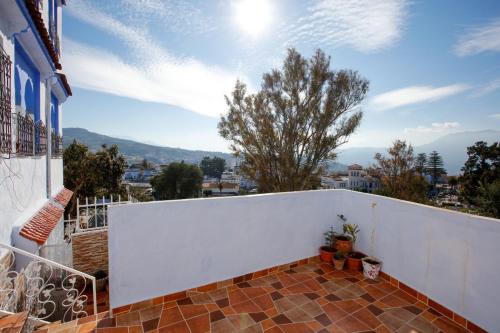 a balcony of a house with a white fence at Dar Sidi Mfedal in Chefchaouene