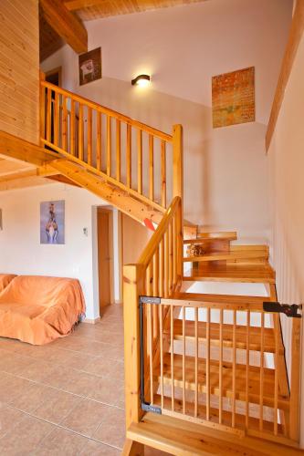 a wooden staircase in a room with a bed at Can Prats in Ríudecañas