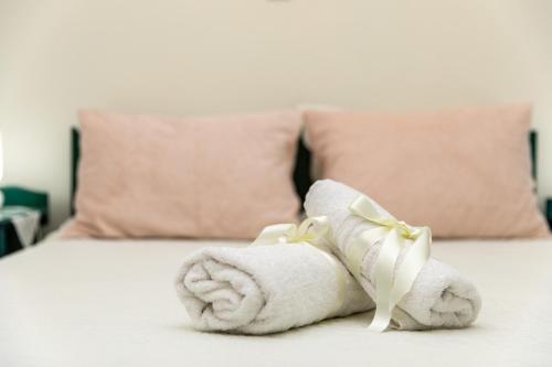 a pile of towels sitting on top of a bed at AnnaMaria Pansion in Naxos Chora