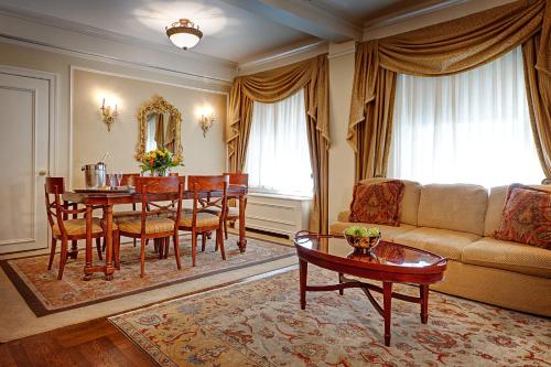 a living room with a table and a couch at Hotel Elysee by Library Hotel Collection in New York