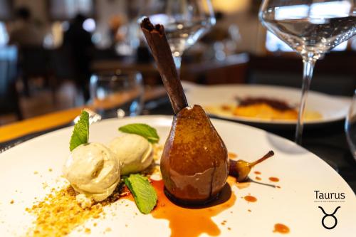 a plate of food with ice cream on a table at Boutique Hotel OchSen Self-Check-In in Bad Ragaz