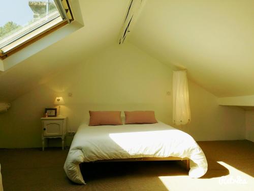 En eller flere senge i et værelse på Les Appartements de Champagne