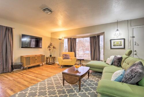 a living room with a green couch and a table at Vintage Downtown Vegas Retreat Less Than 3 Mi to Strip! in Las Vegas
