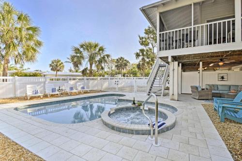 a swimming pool in the backyard of a house at Canal-front Gem with Pool and Hot Tub in Anna Maria in Anna Maria