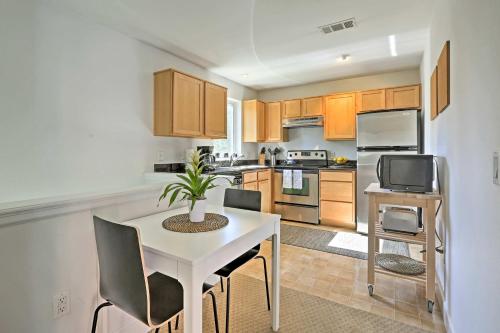 a kitchen with a white table and chairs and a tv at LoHi Apartment with Patio 1 Mi to Downtown Denver! in Denver
