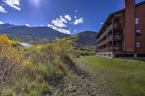 a resort building with mountains in the background at Walk to Main St Frisco Condo with Community Pool! in Frisco