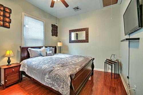 a bedroom with a bed and a flat screen tv at 5 Mi to Bourbon Street Central NOLA Home in New Orleans
