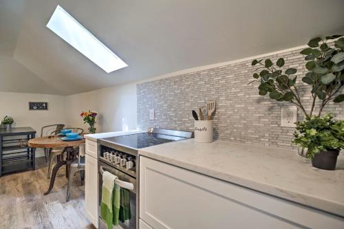 a kitchen with a stove top oven next to a table at Dtwn Golden Apt Less Than 9 Mi to Red Rocks Amphitheater! in Golden