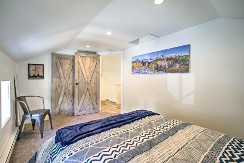 a bedroom with a bed and a chair and a painting at Dtwn Golden Apt Less Than 9 Mi to Red Rocks Amphitheater! in Golden