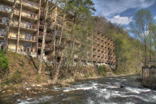 a river in front of a building next to a building at Greystone Lodge on the River in Gatlinburg