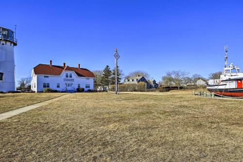 a boat parked in a field next to a lighthouse at 1 Mi to Town and Oyster Pond Beach Chatham Retreat in Chatham