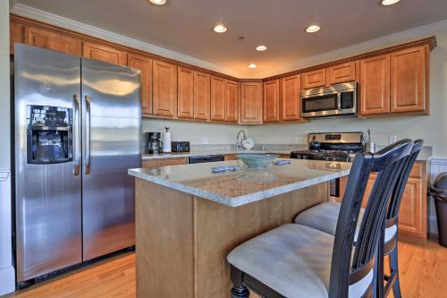 a kitchen with stainless steel appliances and wooden cabinets at 1 Mi to Town and Oyster Pond Beach Chatham Retreat in Chatham