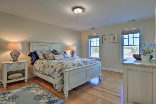 a bedroom with a bed and two windows at 1 Mi to Town and Oyster Pond Beach Chatham Retreat in Chatham