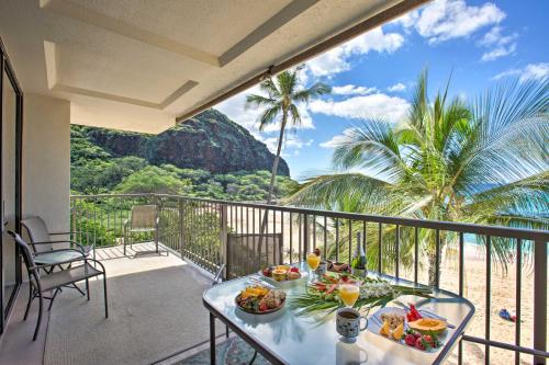 a table with food and drinks on a balcony at Stunning Makaha Condo with Pool Access and Ocean View! in Waianae