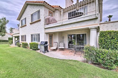 a house with a patio and a grill at Palm Desert Country Club Home with Pool Access! in Palm Desert