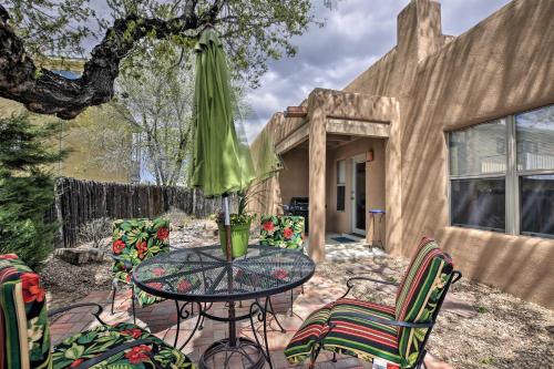 a patio with a table with chairs and an umbrella at 1 Mi to Santa Fe Plaza Quiet Home with Patio in Santa Fe
