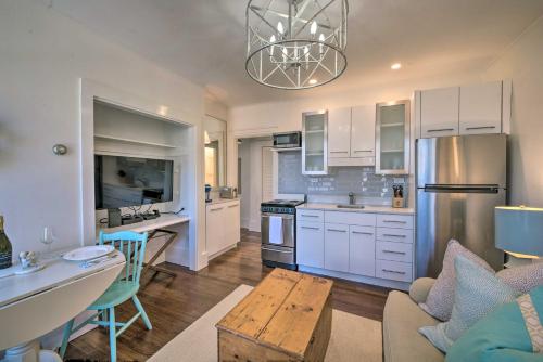 a kitchen and living room with white cabinets and a table at Walk to Attractions Couples Retreat in Nantucket in Nantucket