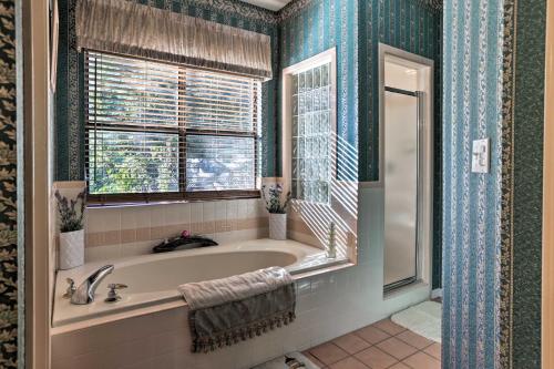 a bathroom with a tub and a window at Secluded Home - Canyon Lake View Near Boat Launch! in Canyon Lake