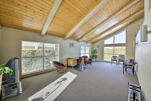 a living room with a wooden ceiling at Lake Pend Oreille Condo with Porch and Mountain View! in Sandpoint
