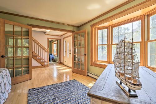 a living room with a model ship on a table at Walk to Beach on Buzzards Bay Onset Home with Deck! in Onset