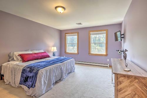a bedroom with purple walls and a bed with a red pillow at Walk to Beach on Buzzards Bay Onset Home with Deck! in Onset
