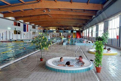 a group of people in a hot tub in a swimming pool at Apartament Morski przy plazy in Darlowko