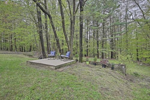 two blue chairs sitting on a bench in a park at Beautiful Lenox Home, 3 Mi to Shakespeare and Co! in Lenox