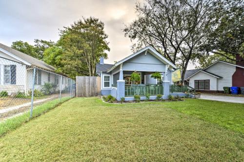 a white house with a porch and a yard at Bearadise Bungalow about 2 Mi to Magnolia Market! in Waco