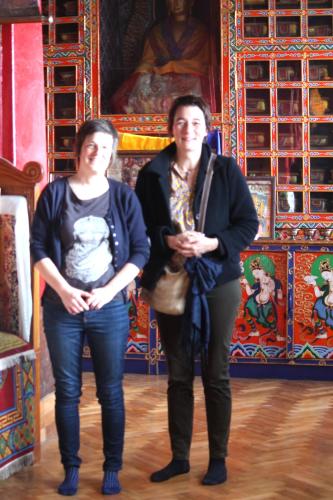 a man and a woman standing in front of a painting at Mansarover Home Stay in Kalimpong