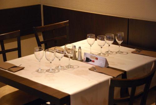 a table with wine glasses on top of it at Charly's Gare in Senningerberg