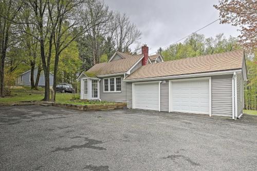 a house with a car parked in front of a driveway at Beautiful Lenox Home, 3 Mi to Shakespeare and Co! in Lenox