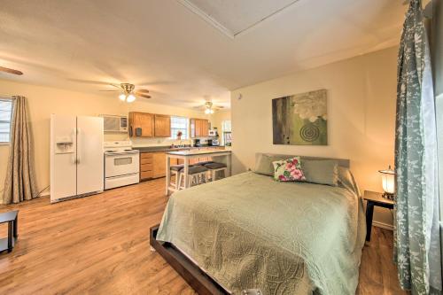 a bedroom with a bed and a kitchen at Cozy Canyon Lake Cottage 1 Mi to Guadalupe River! in Canyon Lake