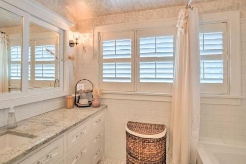 a white bathroom with a sink and a shower at Austin Oasis with Pool and Hot Tub - 2 Mi to Dtwn! in Austin