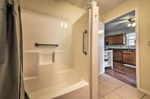 a bathroom with a bath tub and a kitchen at Cozy Canyon Lake Cottage 1 Mi to Guadalupe River! in Canyon Lake