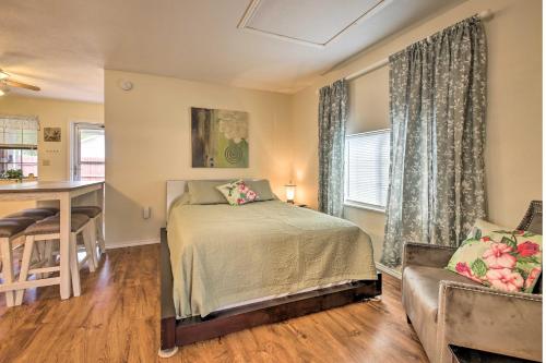 a bedroom with a bed and a table and a kitchen at Cozy Canyon Lake Cottage 1 Mi to Guadalupe River! in Canyon Lake