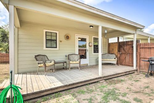 a house with two chairs on a wooden deck at Cozy Canyon Lake Cottage 1 Mi to Guadalupe River! in Canyon Lake