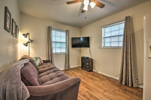 a living room with a couch and a flat screen tv at Cozy Canyon Lake Cottage 1 Mi to Guadalupe River! in Canyon Lake