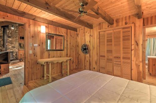 a bedroom with a large bed in a wooden room at Cabin with 3 Acres, Tennis Courts By 4 Ski Mtns in Sandisfield