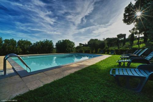 a swimming pool with lounge chairs at Agriturismo Valle Siriaca in Castelnuovo di Porto