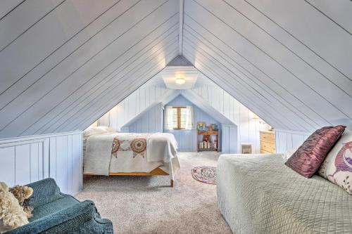 a attic bedroom with a bed and a couch at Walk to Grand Lake Historic Dtwn Cabin! in Grand Lake