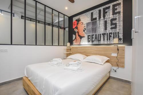 a bedroom with a bed and a poster on the wall at CMG Place d'Italie/ Les Gobelins in Paris