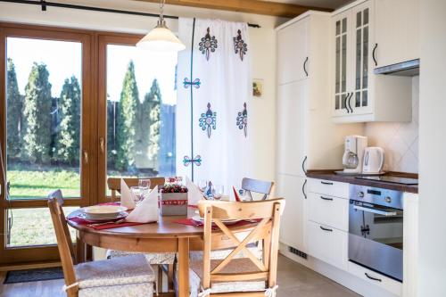 a kitchen with a table and chairs and a window at 4U Apartments - Zakopane in Zakopane