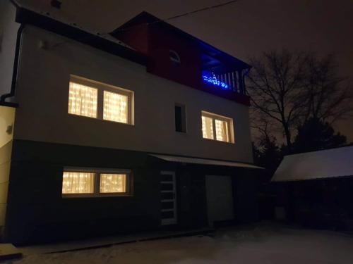 a building with a blue light on top of it at Harsányi vendégház in Miskolctapolca
