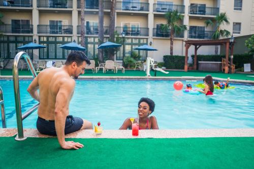 a man and a little boy playing in a pool at Menger Hotel in San Antonio
