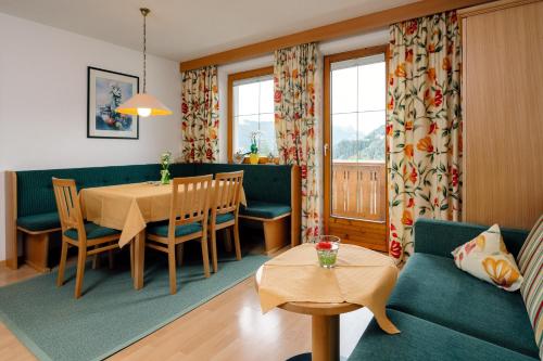 a living room with a table and a dining room at Haus Anemone in Serfaus