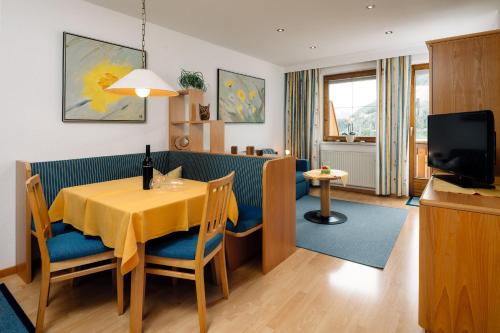 a living room with a table and a dining room at Haus Anemone in Serfaus
