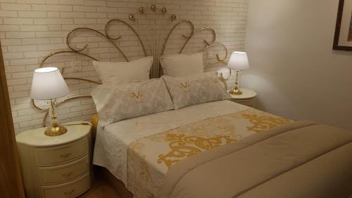 a bedroom with a bed and two lamps on a nightstand at Casco Histórico, con Parking incluido in Zaragoza