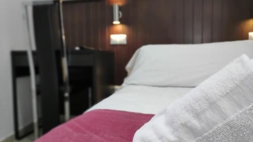 a close up of a bed in a hotel room at Hostal Doña Isabel in Majadahonda